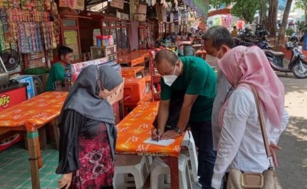 Food inspectors while inspecting one of a street food stall in Cirebon, West Java.